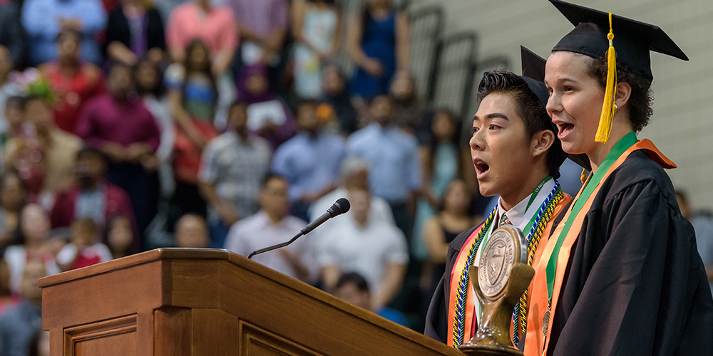 Photo of two students singing.