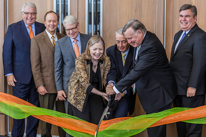 During a daylong celebration, UT Dallas President Richard C. Benson and Jindal School alumni Nancy and Chuck Davidson cut the ribbon to officially open the new alumni center. Among the guests were representatives of the UT System, the University Development Board and the city of Richardson.